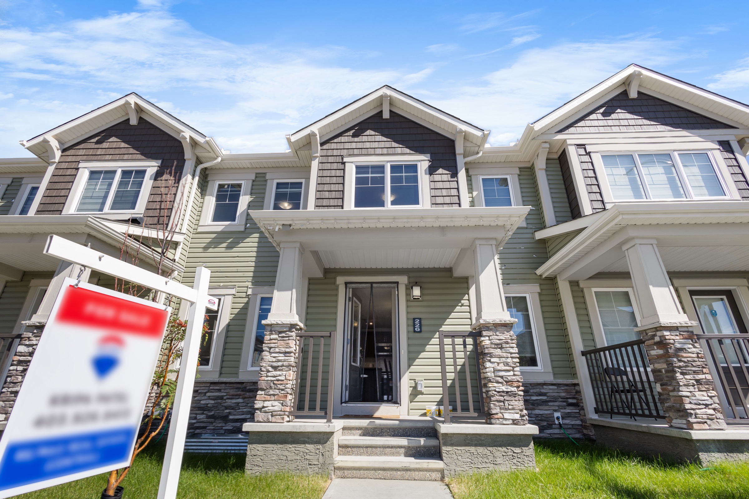 Townhome exterior in daylight under a blue sky