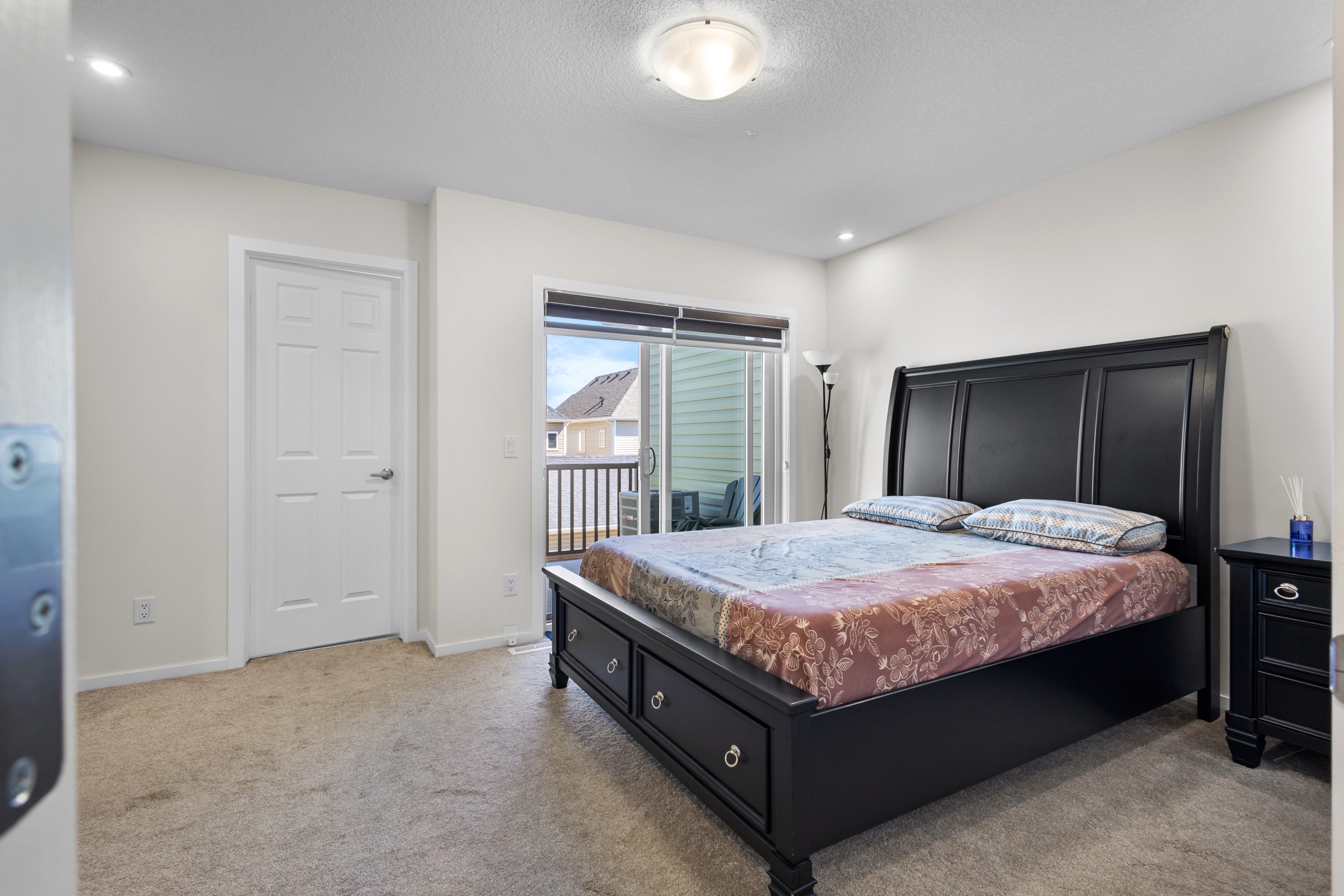 Primary bedroom with a king bed and private balcony access